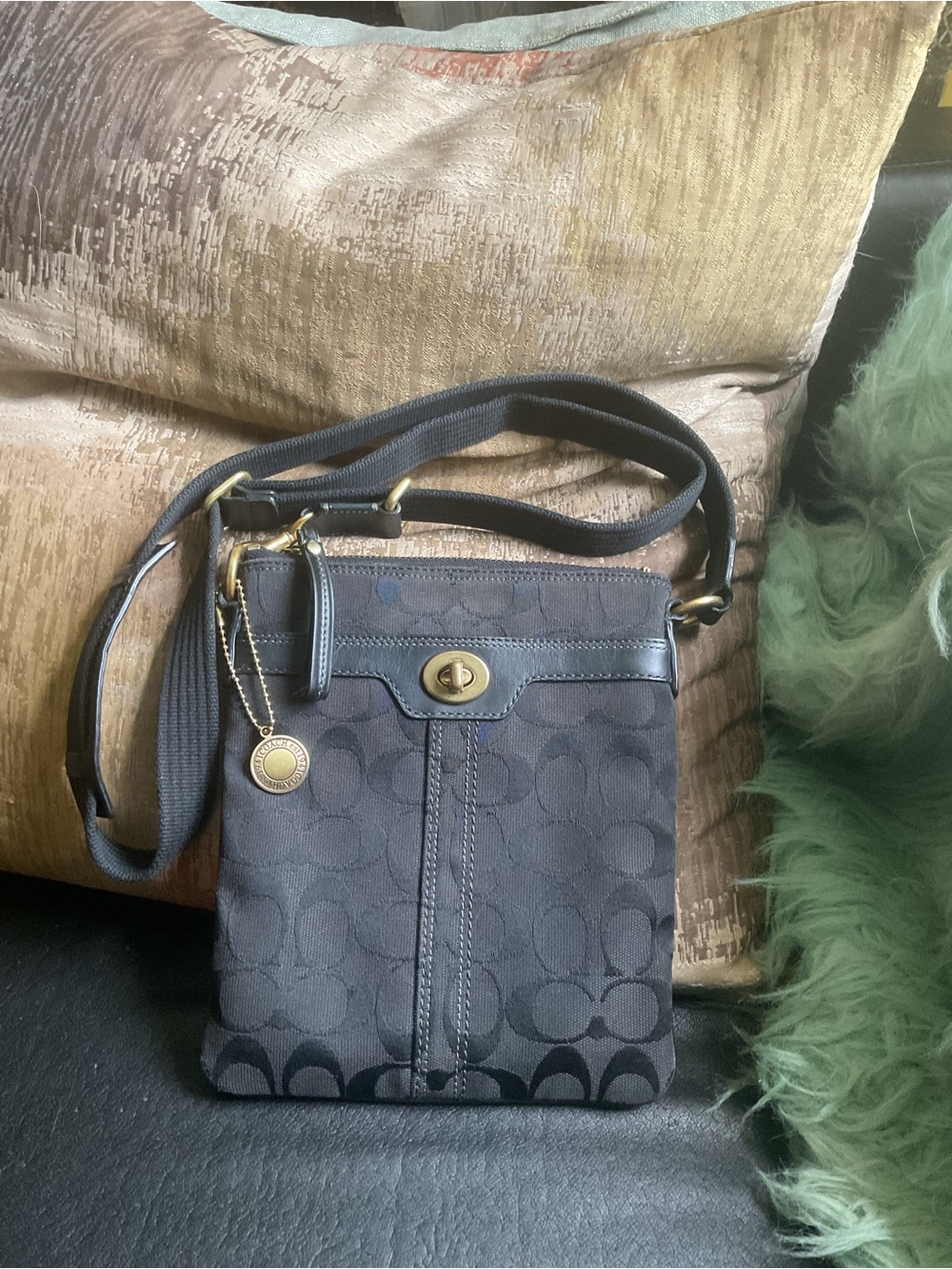 Coach Black Signature Crossbody added the vintage round tag .